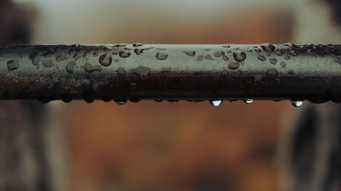 water droplets on gray metal pipe